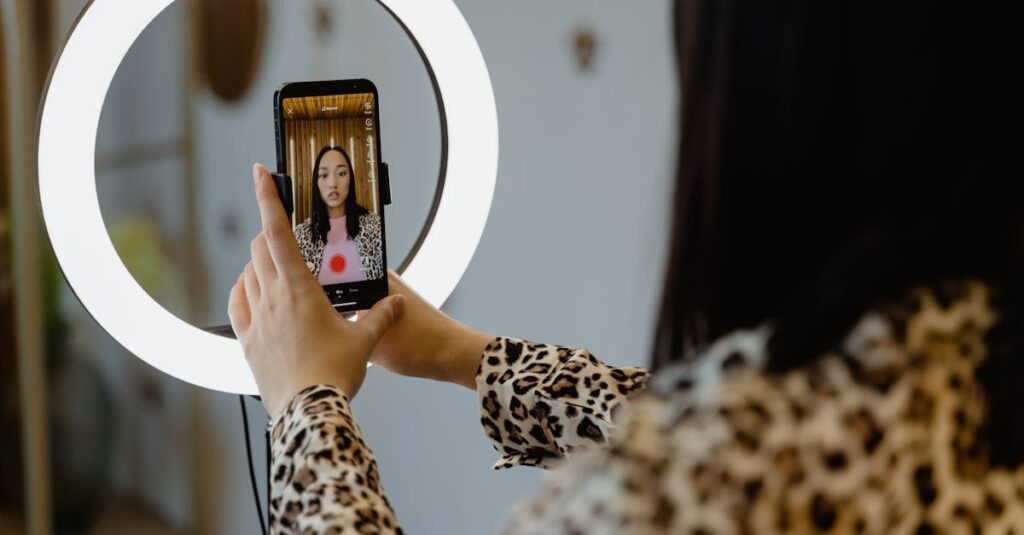 An Asian woman uses a smartphone and ring light for content creation. Ideal for social media themes.