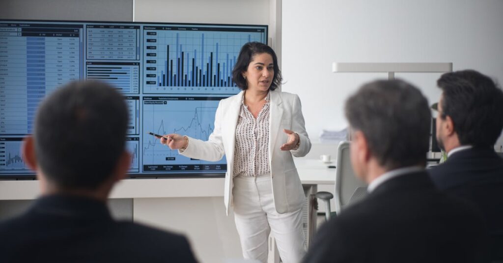 Professional woman presenting stock market data in a modern office setting.